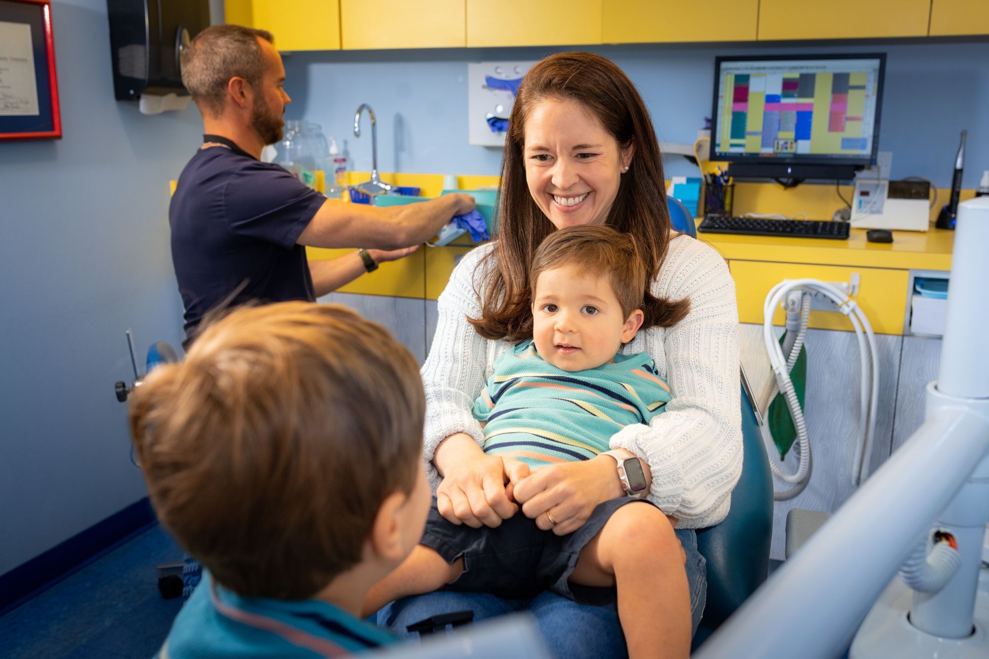 Pediatric Dentist In Philadelphia, Pa 13 A Pediatric Dentist With A Mom, Baby, And Big Brother, Showing The Kid Centric Dental Care Benefits Families Enjoy In Philadelphia, Pa