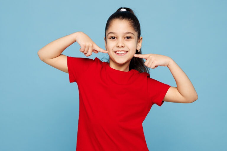 Girl Pointing To Her Smile